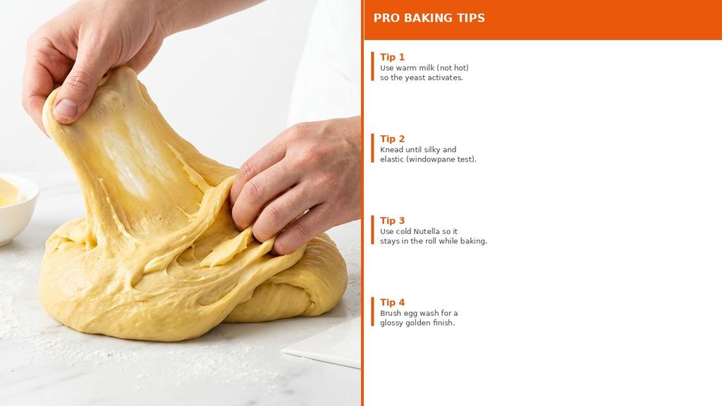 Hands kneading enriched brioche dough in a mixing bowl